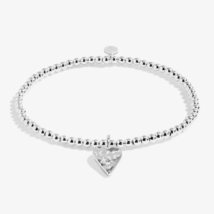 A delicate silver bracelet adorned with a charming heart pendant, perfect for any occasion.