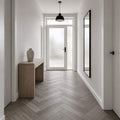 Alsace Oak Rigid LVT Herringbone flooring in a home hallway setting.