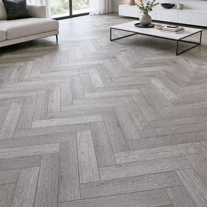 Alsace Oak Herringbone Rigid LVT Flooring in a living room setting.