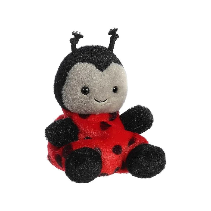 A plush ladybug toy positioned on a white background, highlighting its vibrant colors and soft texture.
