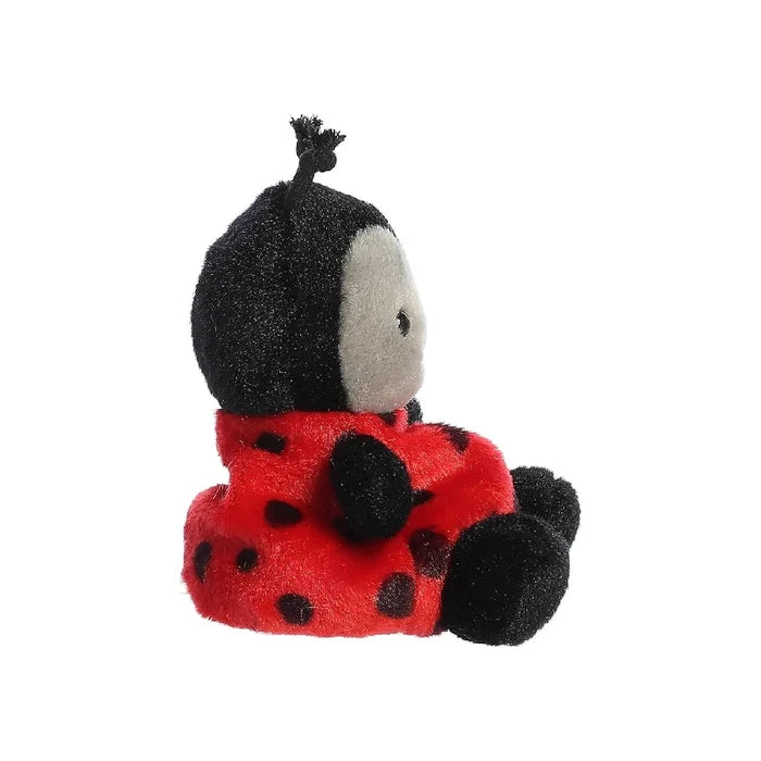 A soft ladybug stuffed animal displayed against a white backdrop, emphasizing its cheerful red and black design.