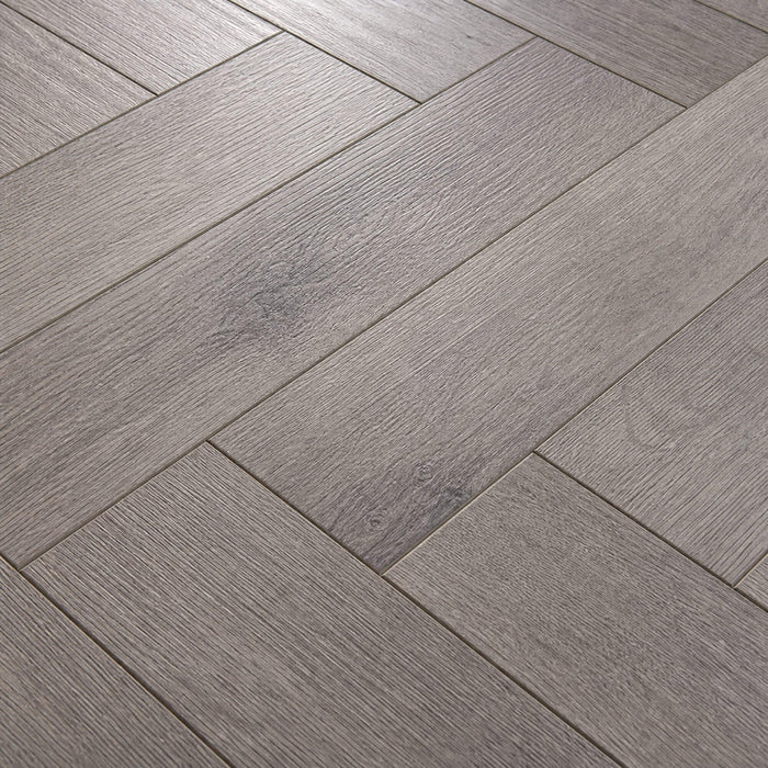 Close-up of the grain and texture of Castle Grey Herringbone laminate flooring.