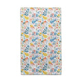A bright towel displaying a floral pattern, complete with colorful birds and leaves, perfect for adding charm to any space.
