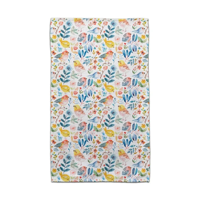 A bright towel displaying a floral pattern, complete with colorful birds and leaves, perfect for adding charm to any space.