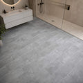 Bathroom with Claros Grey Rigid LVT tile floorings, a shower area and white vanity
 unit.