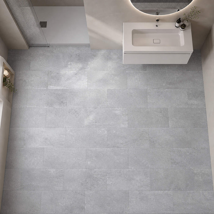 Elevated view of a Claros Grey Rigid LVT tile flooring in a bathroom.