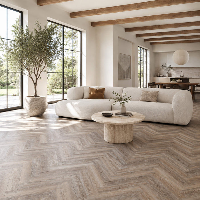 Driftwood Oak Rigid LVT Herringbone flooring in a living room setting.