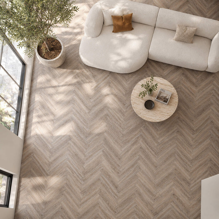 Elevated view of Driftwood Oak Rigid LVT Herringbone flooring in an internal living room setting.