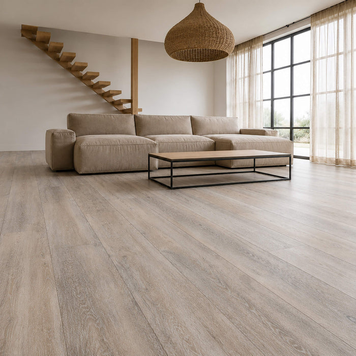 Modern living room with a sectional sofa, coffee table, and Driftwood Oak Rigid LVT wooden floor.