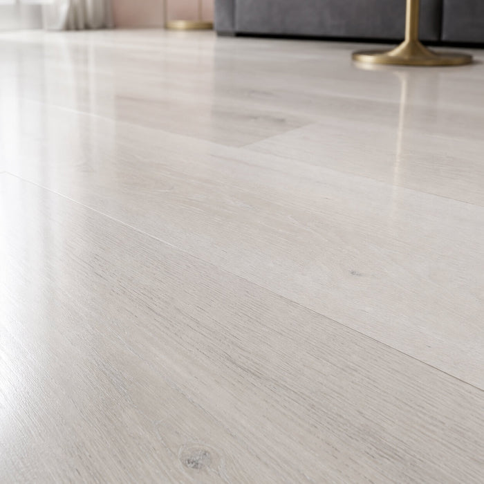 Close-up of Fresco Pearl Super Gloss Laminate Flooring in a home living room setting.