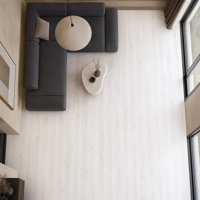 Elevated view of Fresco Snow Gloss laminate flooring in a modern living room setting.