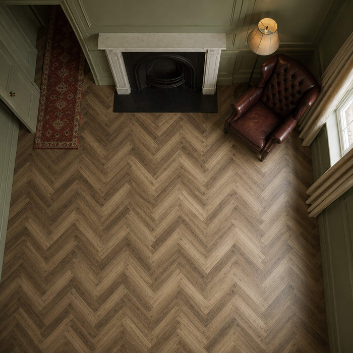 Elevated view of a victorian living room with Fumed Oak LVT herringbone flooring.
