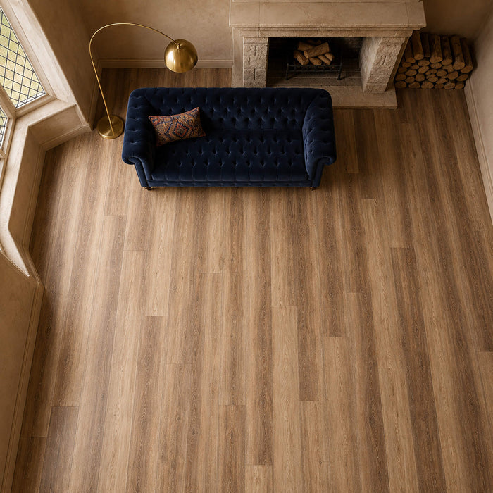 Elevated view of a Fumed Oak Rigid LVT wooden floor with a blue sofa and fireplace in the background.