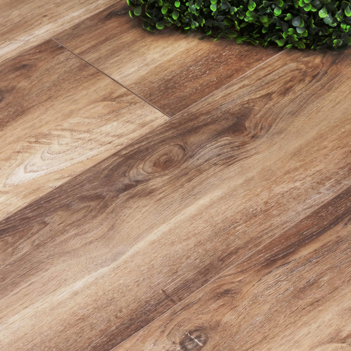 Close-up of Fumed Oak Rigid LVT flooring with a natural finish, showing grain and color variation.