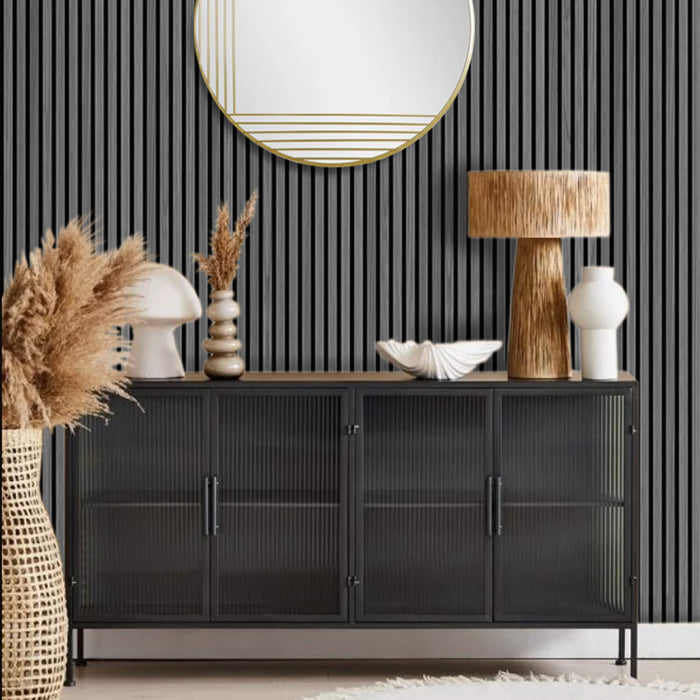 Black sideboard with decorative items against wall with grey slat wall acoustic paneling.