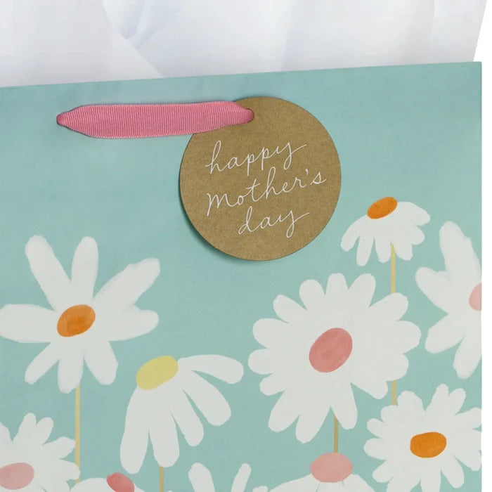 Close‑up of blue daisy Mother’s Day gift bag with gold accents