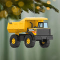 Yellow and black Tonka Mighty Dump Truck ornament with turning wheels on pine branch