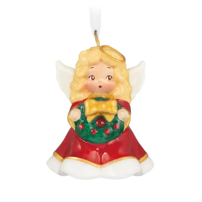 Miniature porcelain angel ornament with red dress, gold trim, and wreath