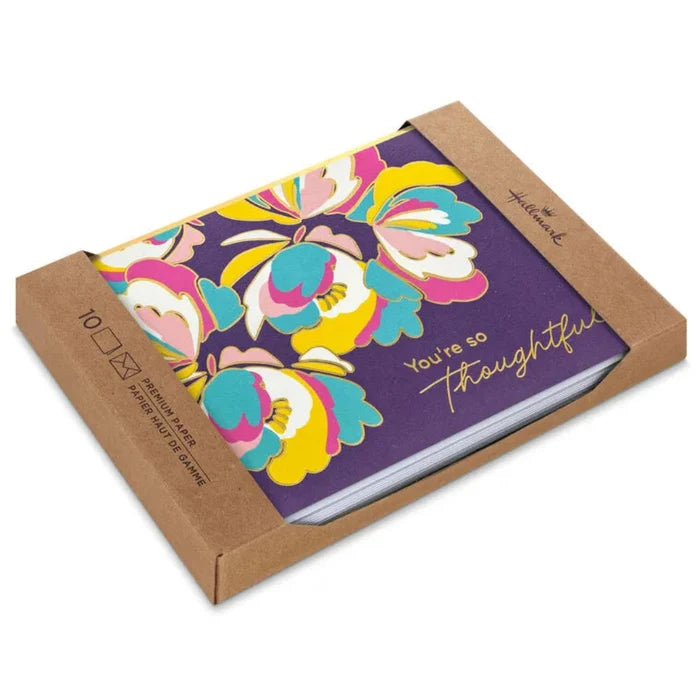 Notebook with colorful floral design and 'You're so thoughtful' text in a brown cardboard box.
