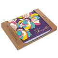 Notebook with colorful floral design and 'You're so thoughtful' text in a brown cardboard box.