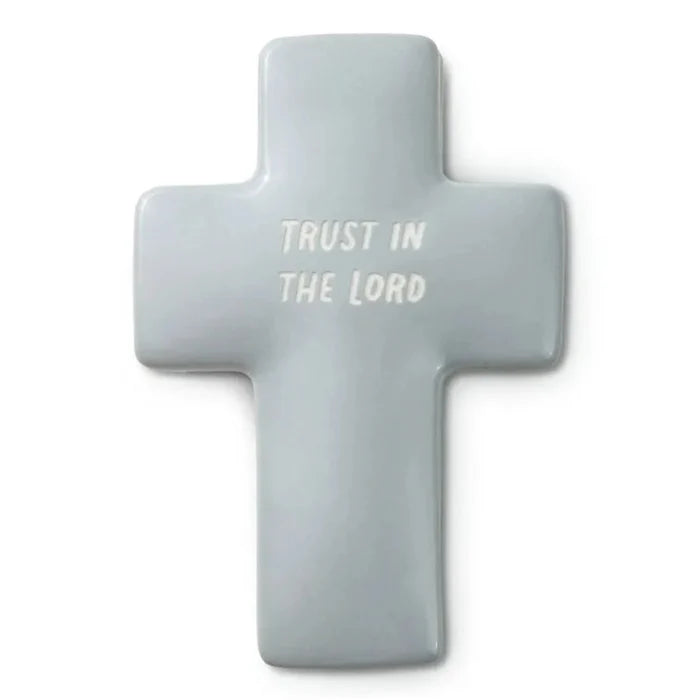 Gray cross-shaped object with 'Trust in the Lord' text on a white background