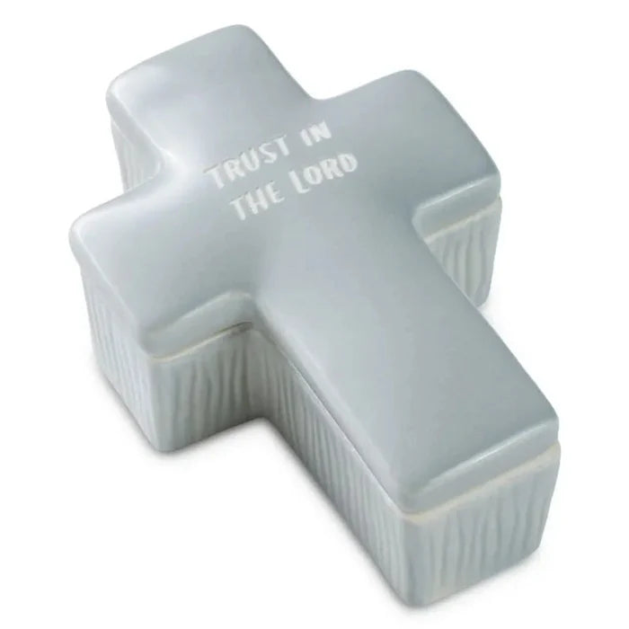 White ceramic cross with 'Trust in the Lord' text on a white background