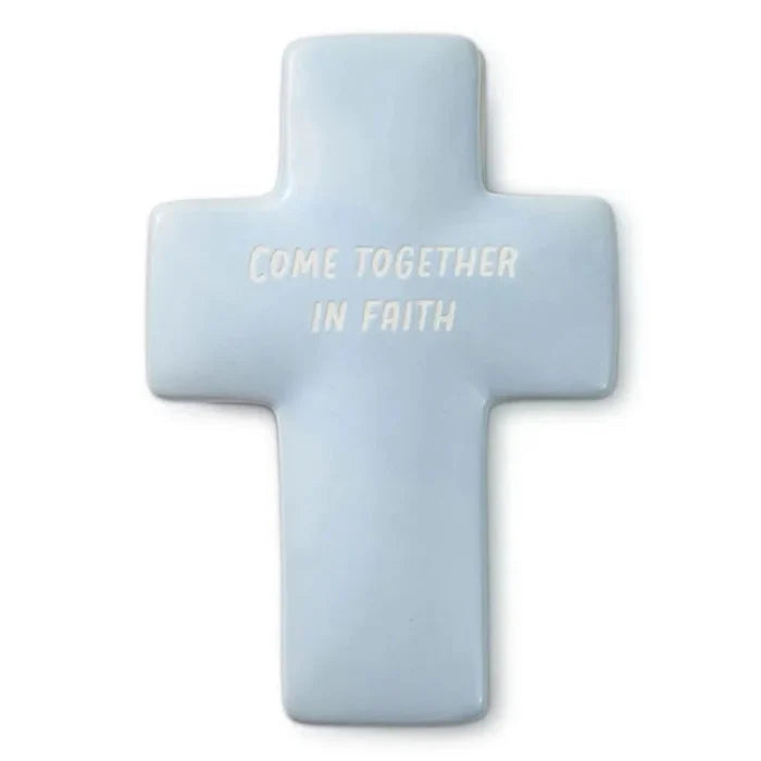Light blue cross-shaped pillow with 'Come Together In Faith' text on a white background