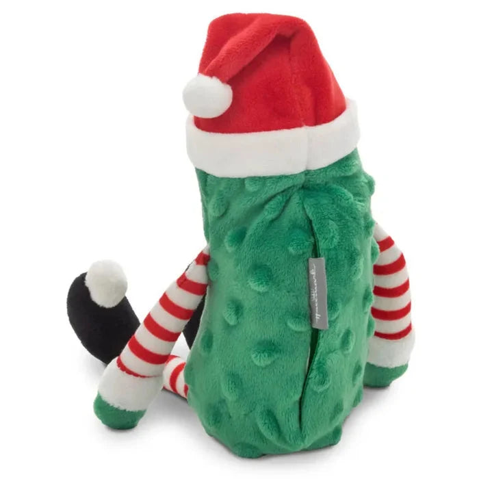Green plush toy with a red Santa hat on a white background