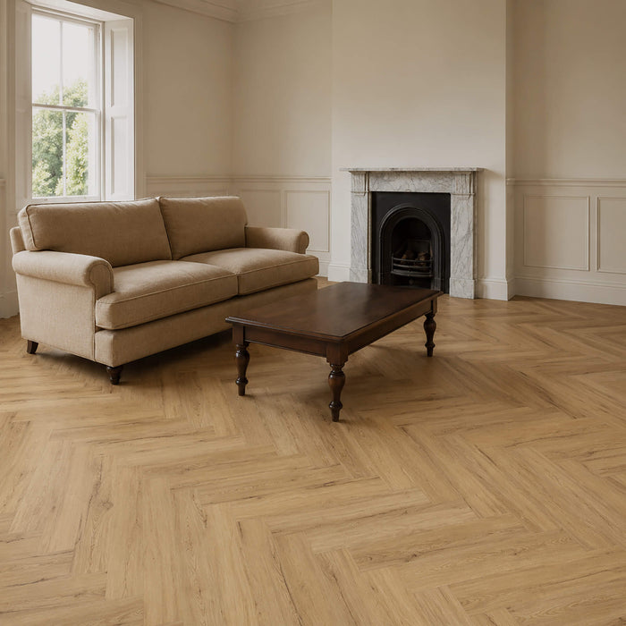 Living room with beige sofa, wooden coffee table, Heritage Oak Rigid LVT Herringbone floor and fireplace.