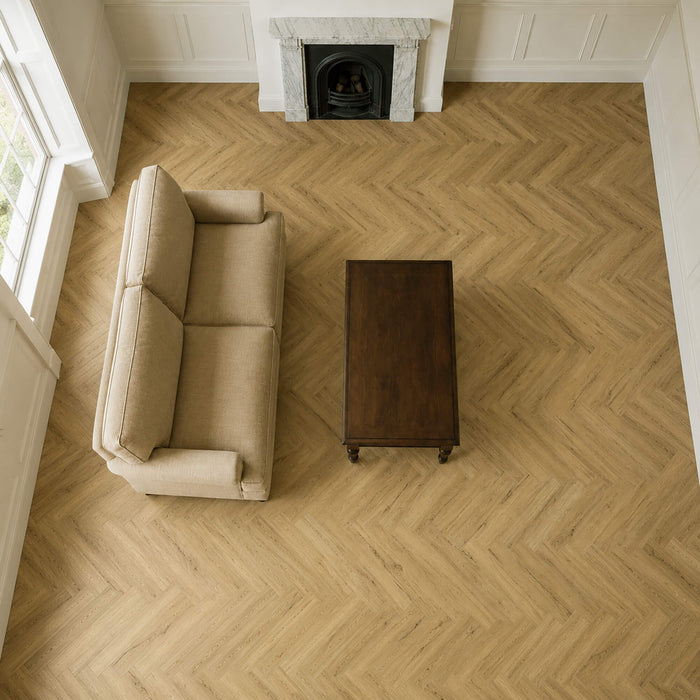 Elevated view of a Heritage Oak Rigid LVT Herringbone floor in a living room setting.