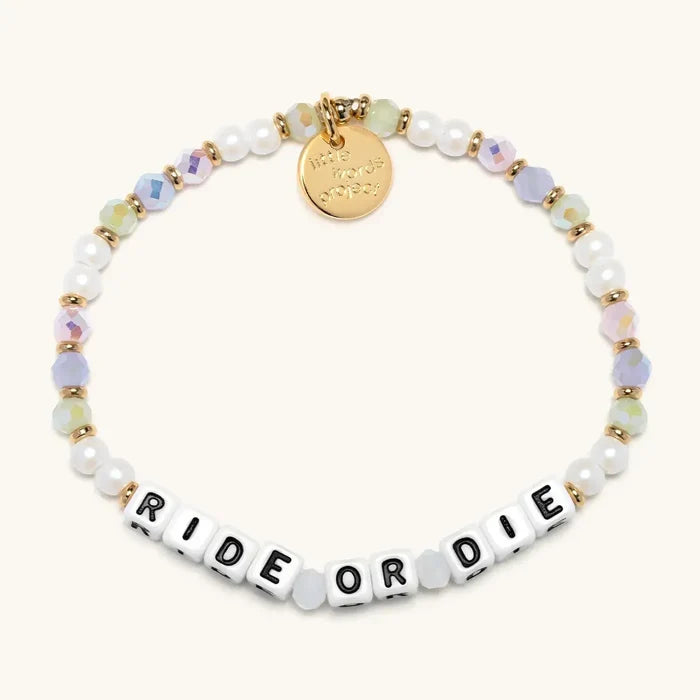 Bracelet with 'Ride or Die' beads and gold charm on a white background