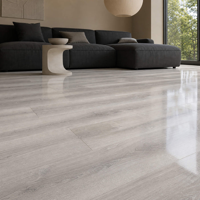 Modern living room with a grey sofa and Manhattan Grey super gloss laminate flooring.