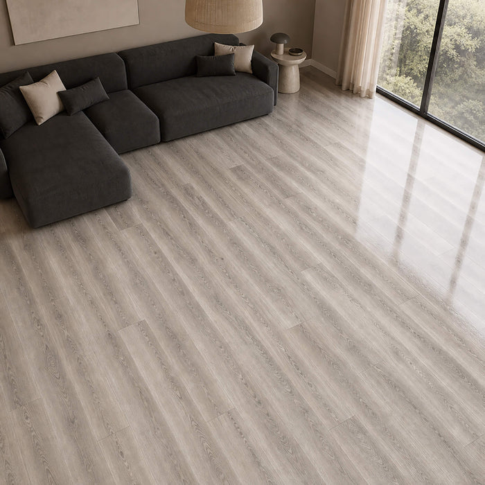 Living room with a grey sectional sofa on Manhattan Grey super gloss laminate flooring.