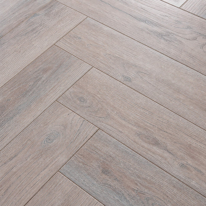 Close-up of the grain and texture of Manor Grey Oak Herringbone laminate flooring.