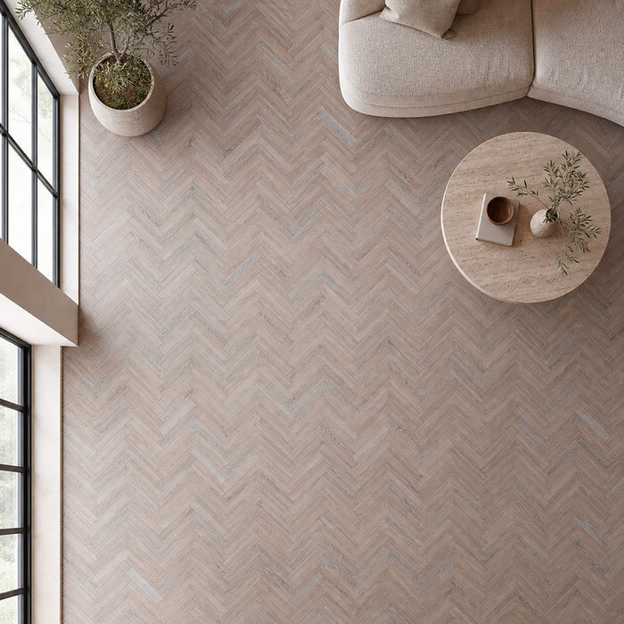 Elevated view of Manor Grey Oak Herringbone laminate flooring in a living room setting.