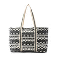 A tote bag featuring a design of alternating black and white stripes.