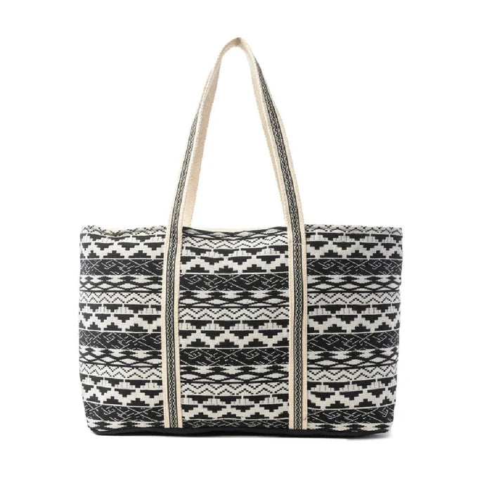 A tote bag featuring a design of alternating black and white stripes.
