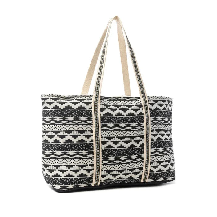 A stylish tote bag with a pattern of bold black and white stripes.