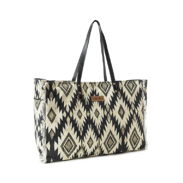 Spacious tote bag adorned with a bold black and white tribal pattern.