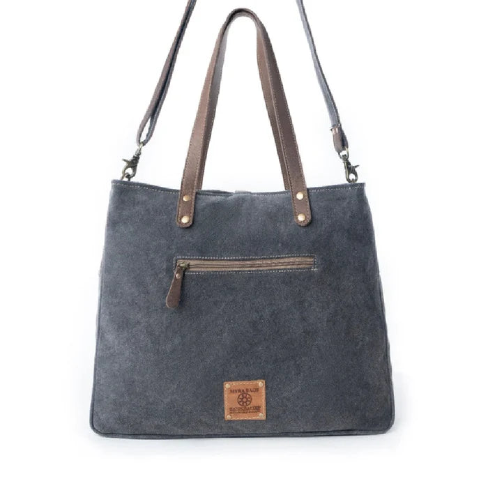 A roomy tote bag constructed from cotton and linen, offering a practical yet fashionable accessory for daily use.