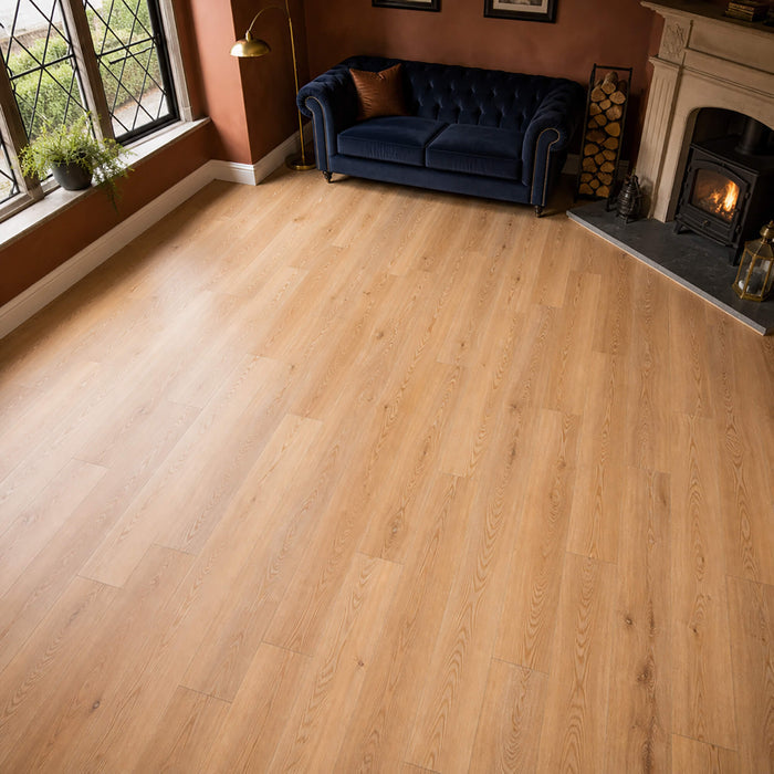 Living room with Natural Oak Rigid LVT flooring, blue sofa, and fireplace.