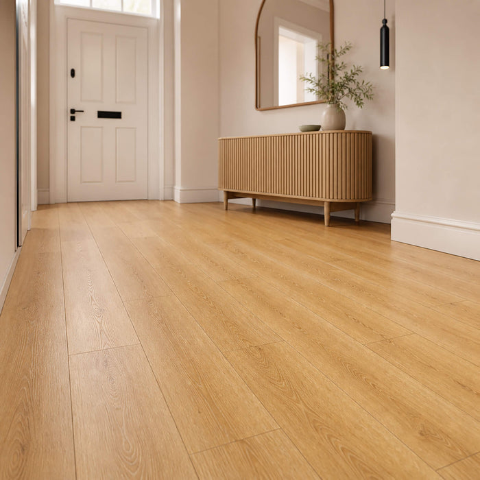 New England Oak Prestige laminate flooring in a hallway with a cabinet and mirror.