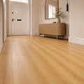 New England Oak Prestige laminate flooring in a hallway with a cabinet and mirror.