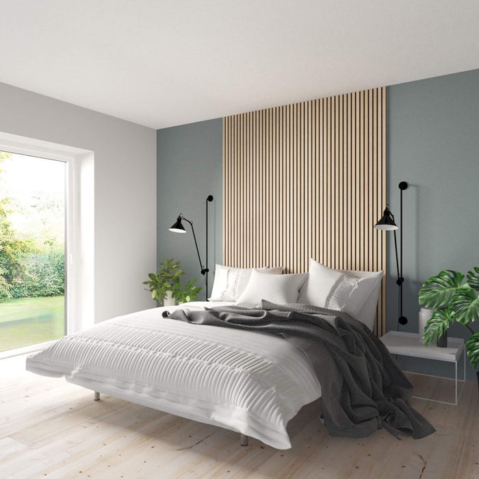 Oak Acoustic Slatwall Panelling installed in a bedroom behind the bed.