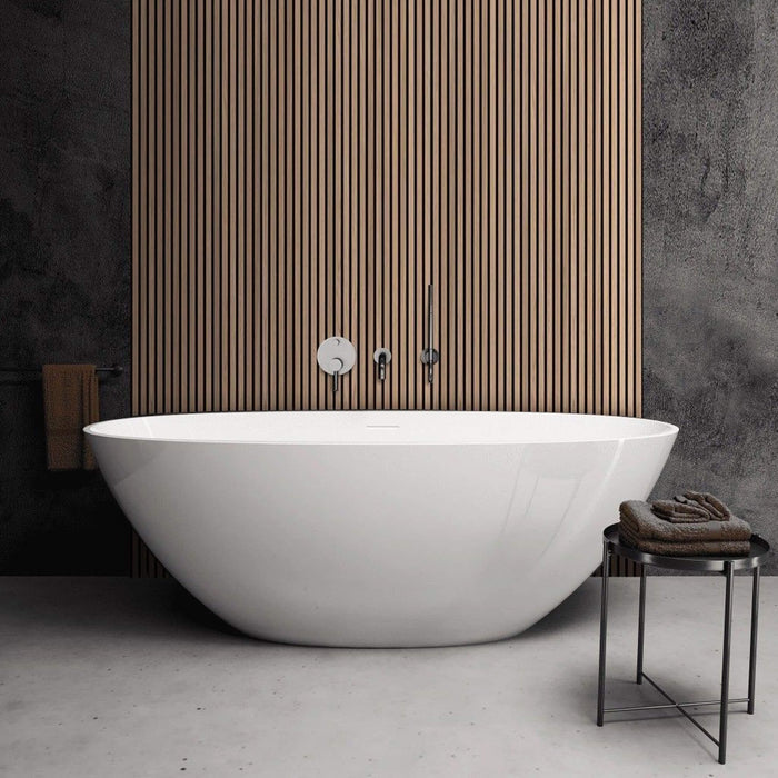 Modern white freestanding bathtub in a bathroom with Oak Aqua Slatwall Panelling and tiled walls.