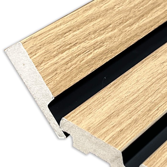Close-up of a wooden strip with metal corner caps on a white background