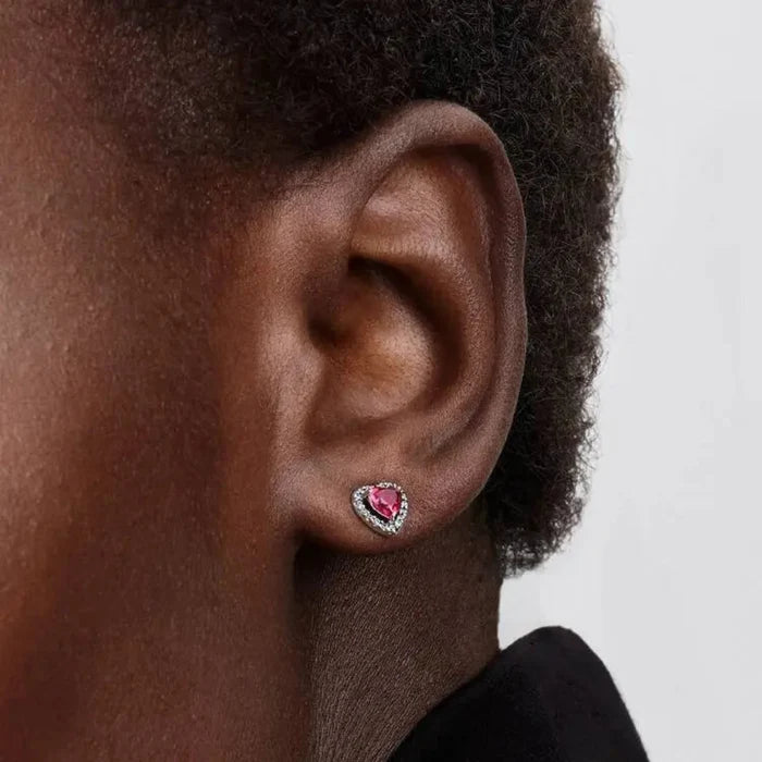 Close-up of the Pandora Elevated Red Heart Stud Earrings in sterling silver showing red heart-shaped stones with a sparkling halo.