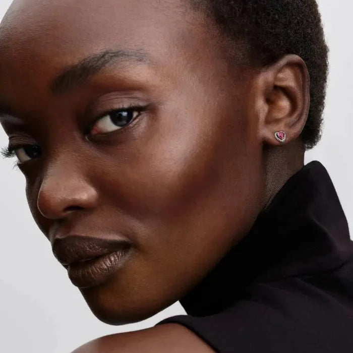 Woman wearing the Pandora Elevated Red Heart Stud Earrings in sterling silver.