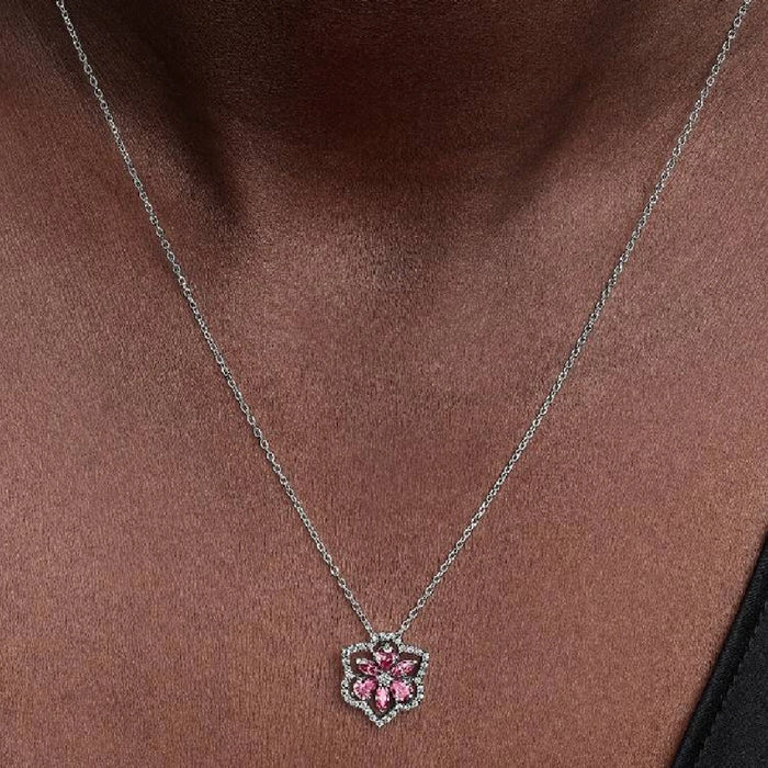 A pink flower pendant set with diamonds, beautifully showcased on a slender chain.