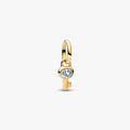 Close‑up of gold‑plated mini key charm featuring clear cubic zirconia
